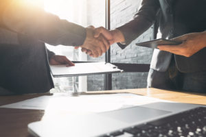 Professional handshake representing the trusted relationships Meer and Company builds with property owners and tenants